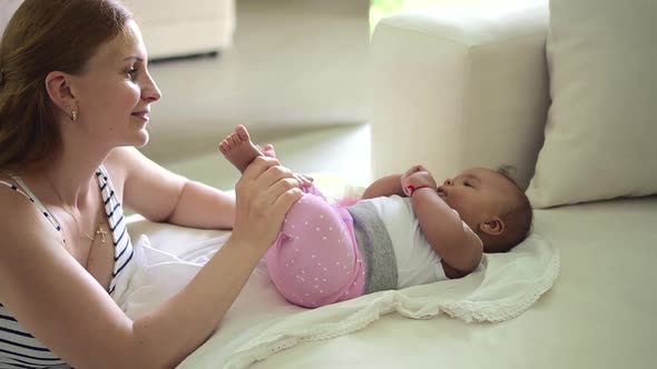 Mother Kissing Little Baby and Staying in Apartment Room During Pandemic Spbd