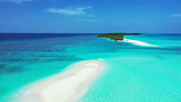 Tropical drone copy space shot of a white sandy paradise beach and blue ocean background