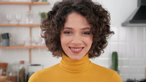 Close Up Smiling Face Curly Woman Looking Camera Standing at Home Kitchen