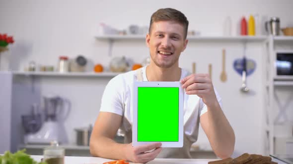 Handsome Man Holding Tablet With Green Screen, Cooking Courses Application
