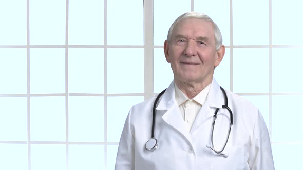 Old Senior Smiling Doctor with Stethoscope.