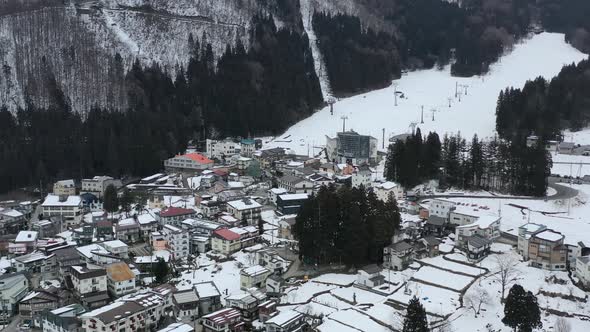 aerial of chair ski lift in nozawa onsen village during early winter in nagano japan