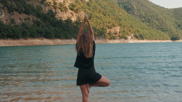 Young Woman Tourist Practicing Yoga in the Nature, Female Happiness, Caucasian Woman Is Practicing