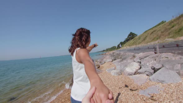 POV Shot of Girl Pulling Boyfriend Along The Beach His Hand in Slowmotion