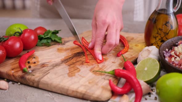 Woman Hands Slicing Chopping Chili Pepper at Domestic Kitchen