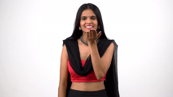 Happy Indian girl giving a flying kiss in Indian attire