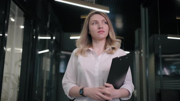 Beautiful Business Woman Walking in Office Corridor