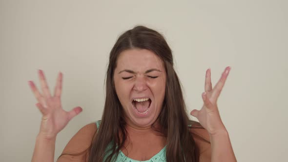 Portrait of Plump Woman Crying Expressing Pain on White Background