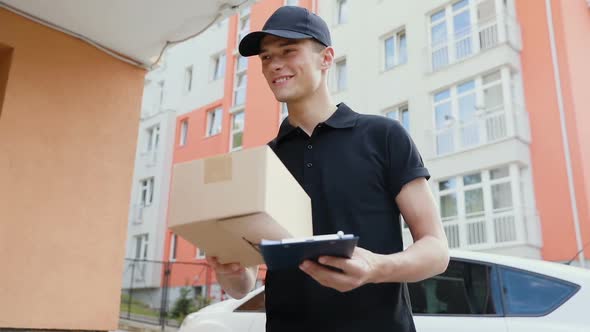 Delivery Service. Courier Delivering Box To Woman