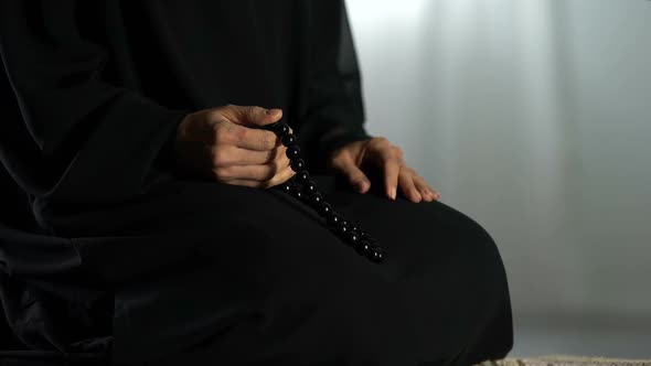 Arab Female Sitting on Prayer Mat, Counting Islamic Beads, Asking Forgiveness