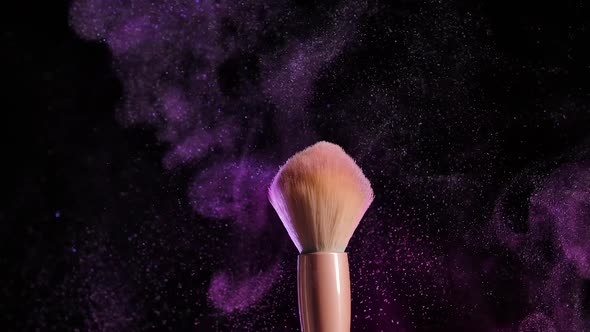 From the Touch of Two Makeup Brushes Colorful Glittering Powder or Blush Particles Float in the Air