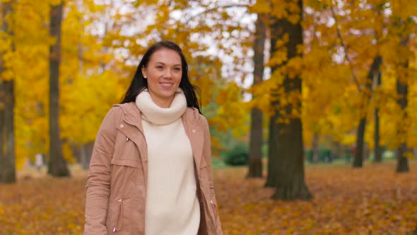 Happy Young Woman Walking in Autumn Park 4