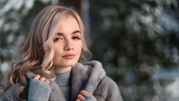 Portrait of Seductive Lady Posing in Grey Fur Coat at Forest