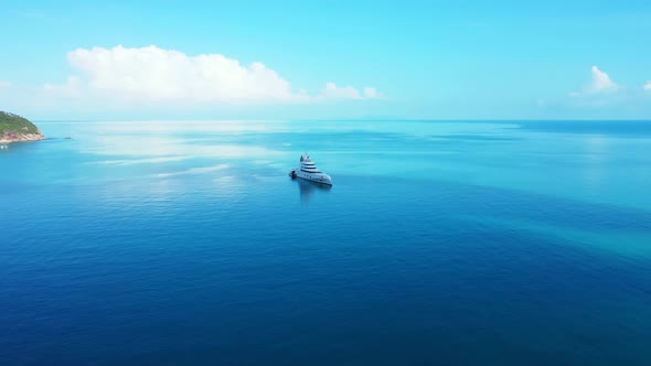 Aerial top view scenery of relaxing coastline beach voyage by blue green ocean with white sandy back