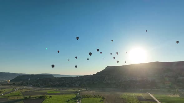 4K Aerial view of Goreme. Colorful hot air balloons fly over the valleys.