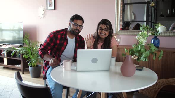 Young Indian Couple Chatting with Relatives Via Videoconference Videocall Application