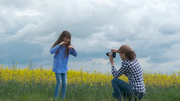 A female with a camera takes pictures of a child.