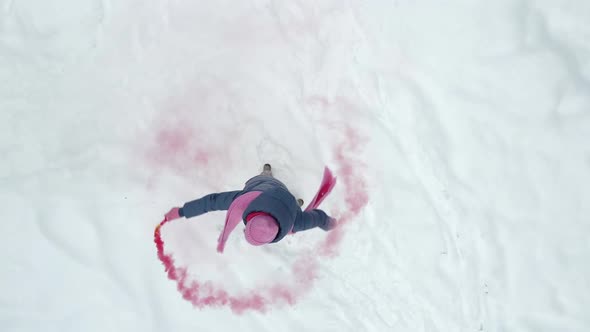 Woman in Pink Clothes a Scarf and a Hat is Spinning Around the Axis