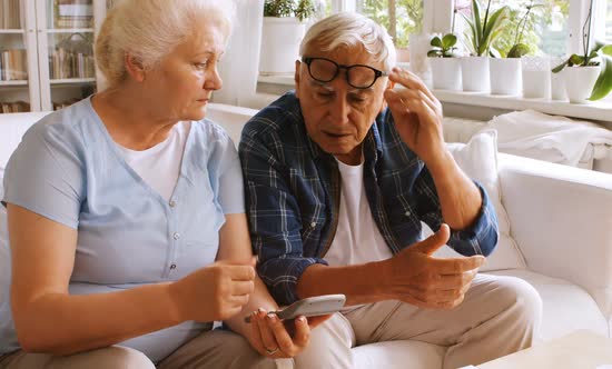 Worried senior couple calculating bills