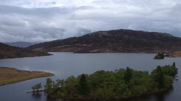 Tilt down droneshot of scottish higland lake