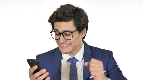 Young Businessman Cheering for Success on Smartphone White Background