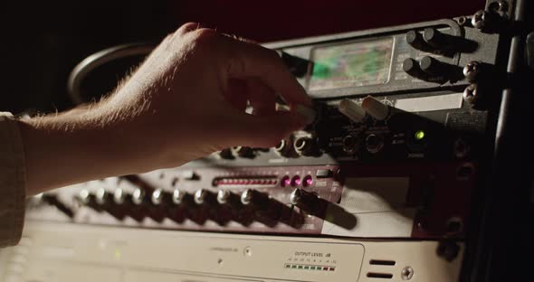 Musician Tuning Amplifier in Studio