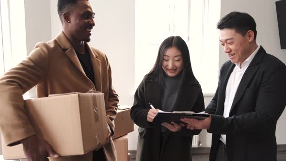 Realtor Explaining Agreement To Couple In New Apartment