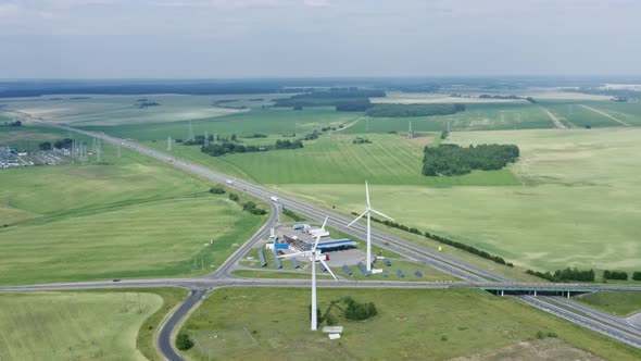 Aerial View Windmills Wind Turbines Producing Clean Ecological Electricity By Road in Green