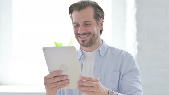 Video Call on Tablet By Talking Young Man