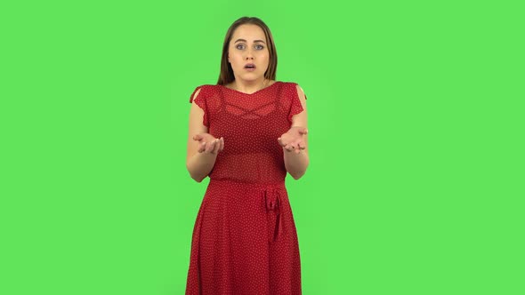 Tender Girl in Red Dress Is Listening To Information, Shocked and Very Upset. Green Screen