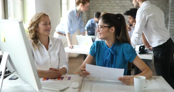 Business People Working Together on Project in Modern Office