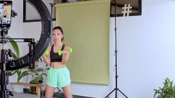 Fitness instructor broadcasting online class from her studio