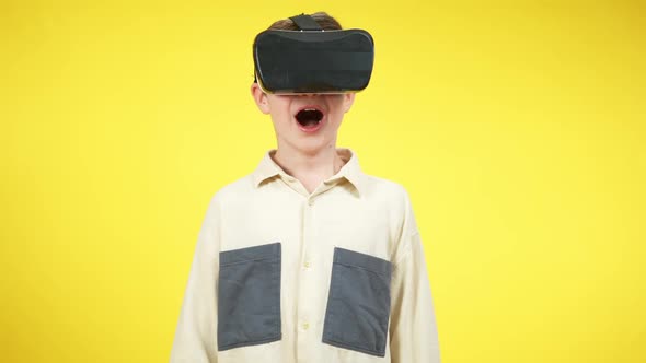 Caucasian Boy in VR Headset Screaming at Yellow Background