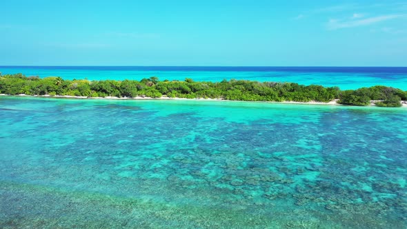 Natural flying clean view of a white paradise beach and aqua blue water background in vibrant 