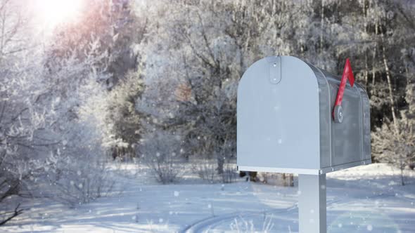Mailbox with a Christmas Greeting Card on the Background of a Winter Forest