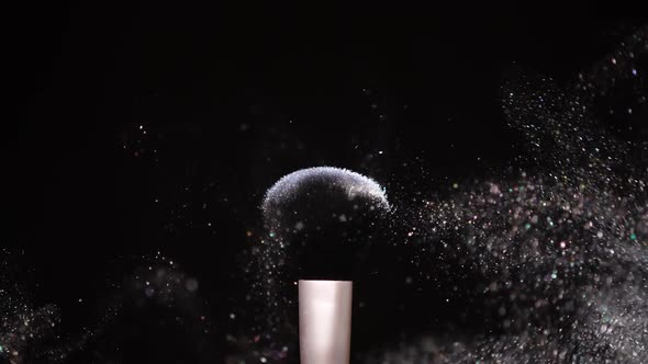 Make Up Brush with Colored White Powder at Black Background Slow Motion