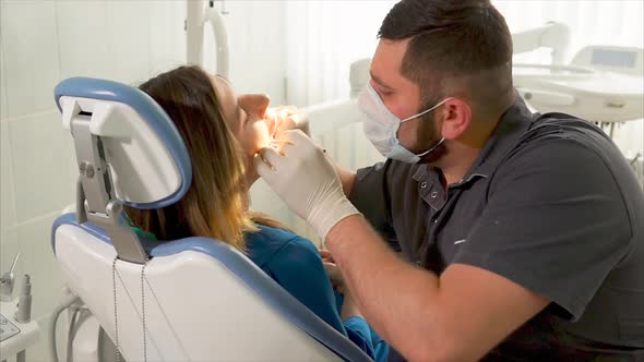 Dentist Examining the Woman Patient