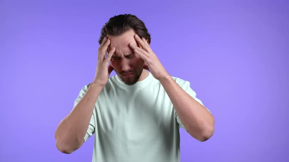 Young Man Portrait His Head is Spinning Around on Violet Background