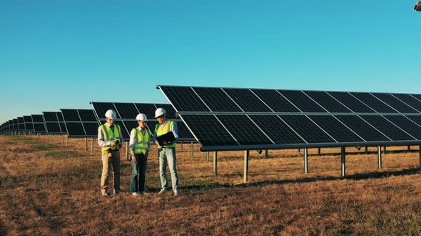 Engineers Are Talking in the Middle of a Solar Power Field. Renewable Energy, Solar Electricity