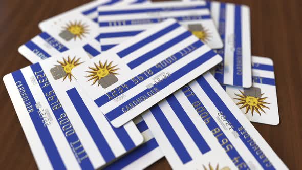 Pile of Credit Cards with Flag of Uruguay alt