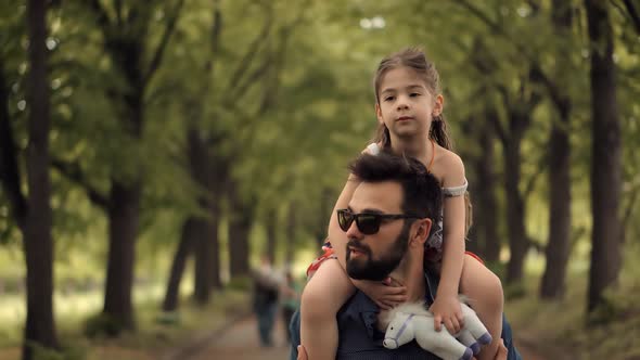 Father's Day. Kid Having Fun In Park. Carefree Dad With Preschool Daughter Enjoy Activity Together.