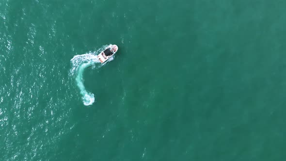 Motor Boat Sailing In The Turquoise Sea In Benidorm Spain Making Foamy Waves