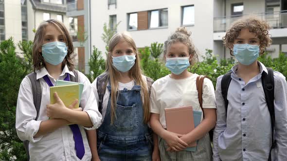 Group of Schoolchildren in Medical Masks To Protect Against Coronavirus.