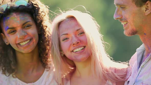 Two Happy Couples Enjoying Double Date at Colours Festival on Bright Sunny Day