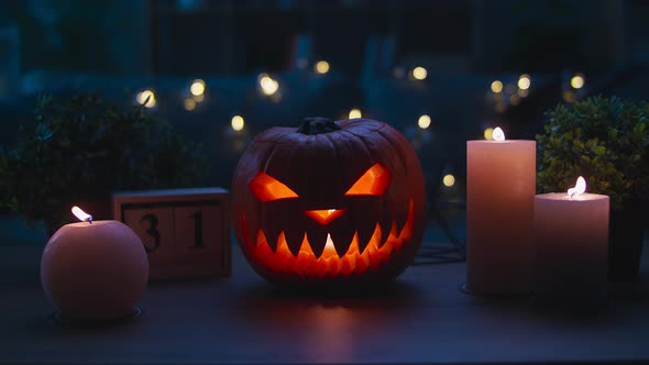 Smiling Halloween Pumpkin on the Wooden Table in a Mystic Night