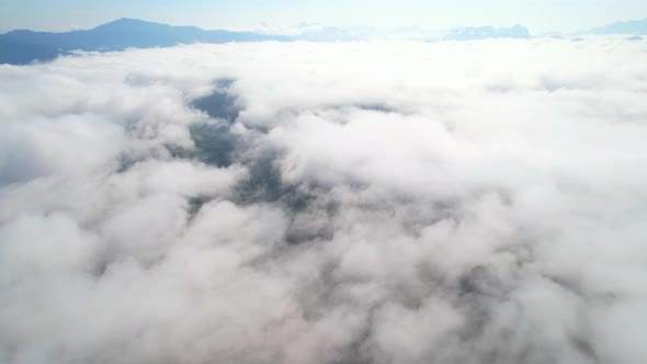 Aerial top view from drone above the mountain fog in the morning
