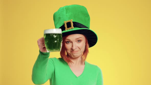 Woman with leprechaun's hat and beer making a toast