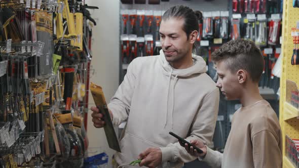 Child and Father Choosing Products at Hardware Store