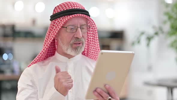 Senior Old Arab Businessman Doing Video Call on Digital Tablet