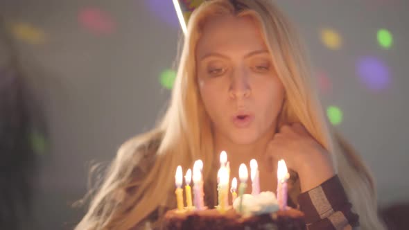 Portrait Cute Blond Woman Blowing the Candles on the Cake